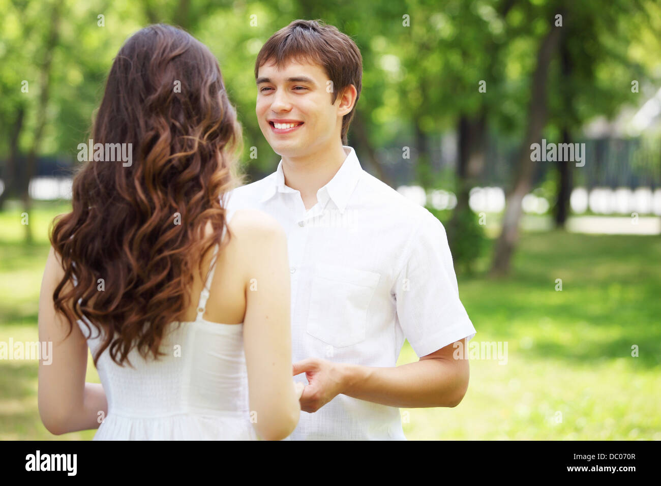 Young love Couple smiling under blue sky Stock Photo - Alamy