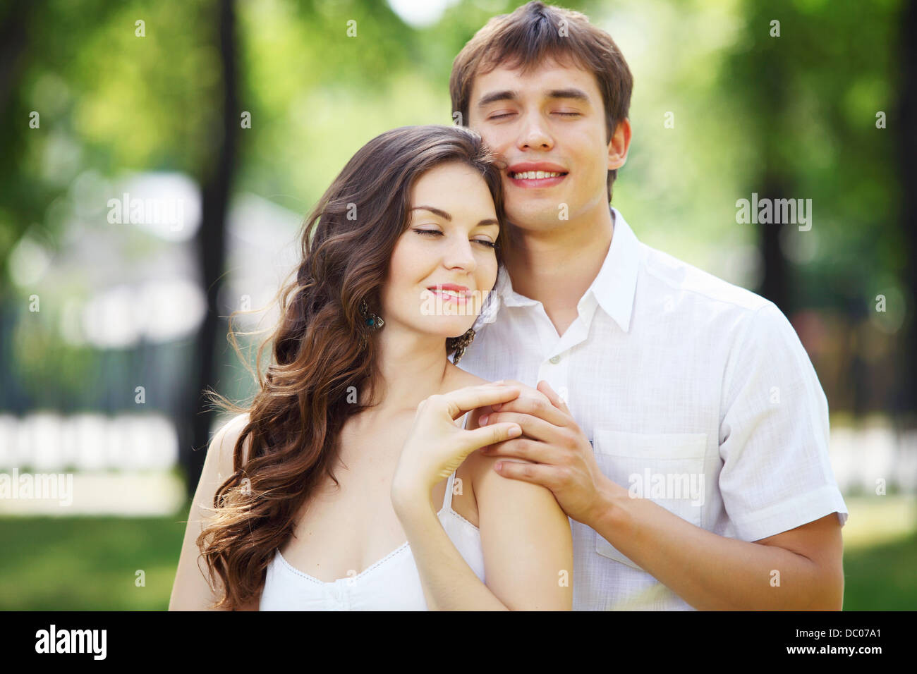 Young love Couple smiling under blue sky Stock Photo - Alamy