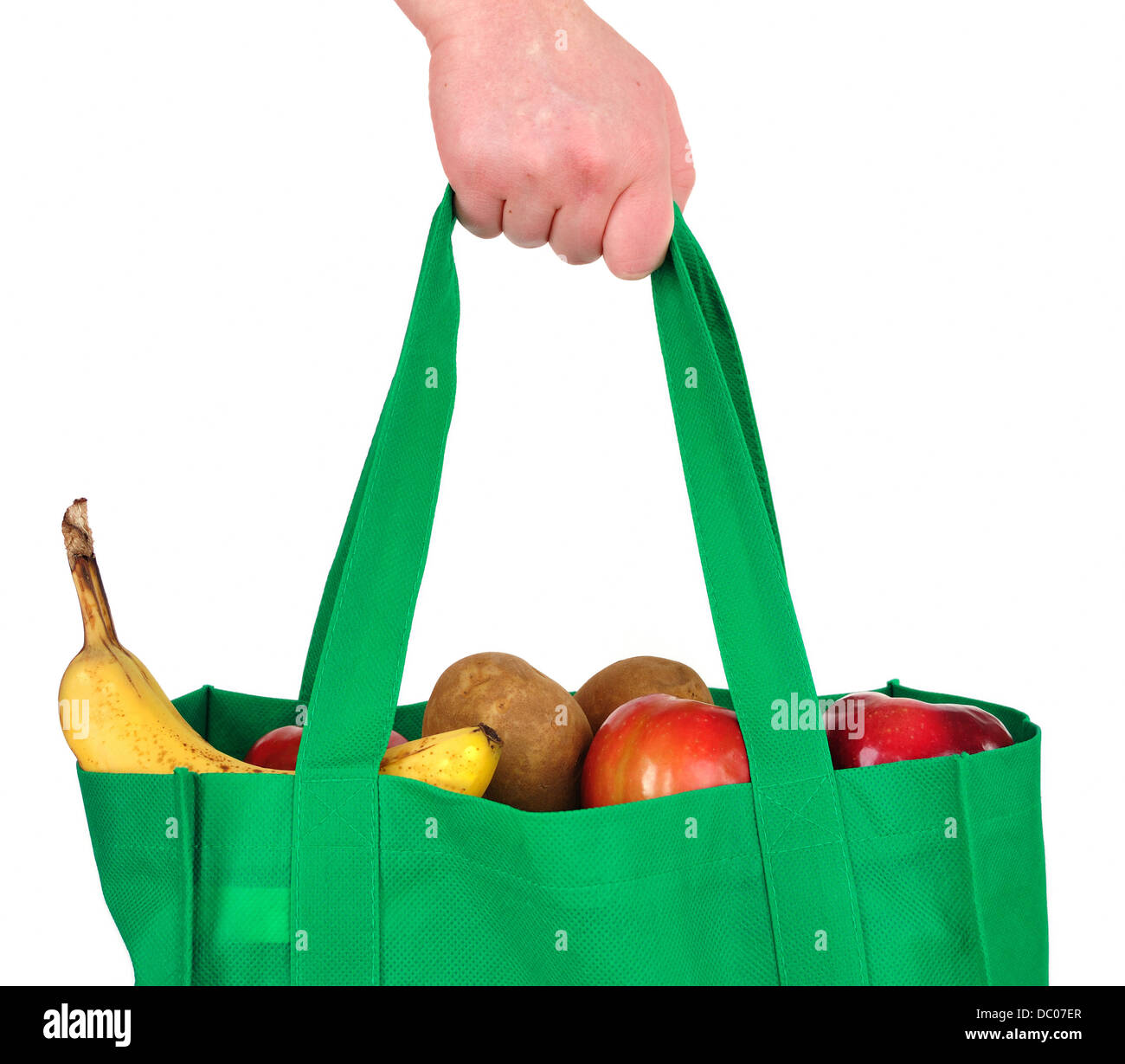 Carrying shopping - fruit and vegetables - in a green reusable shopping bag Stock Photo