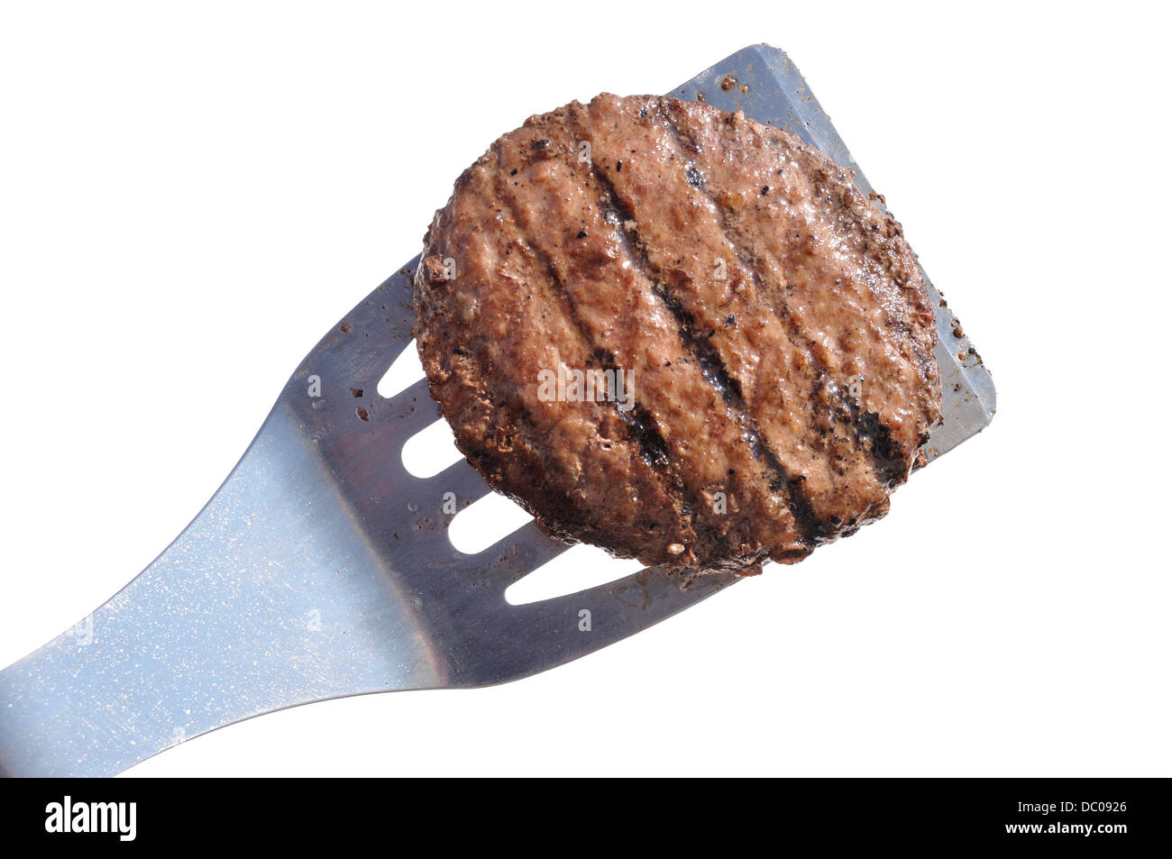 Grilled Hamburger Patty on a Spatula Isolated on White Stock Photo