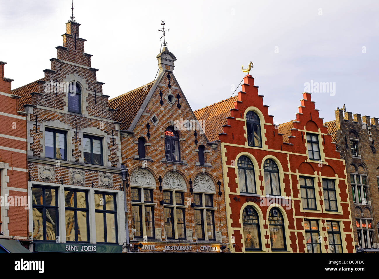 Bruges Belgium Flanders Europe Brugge gabled guild houses in Market Square converted to restaurants Stock Photo