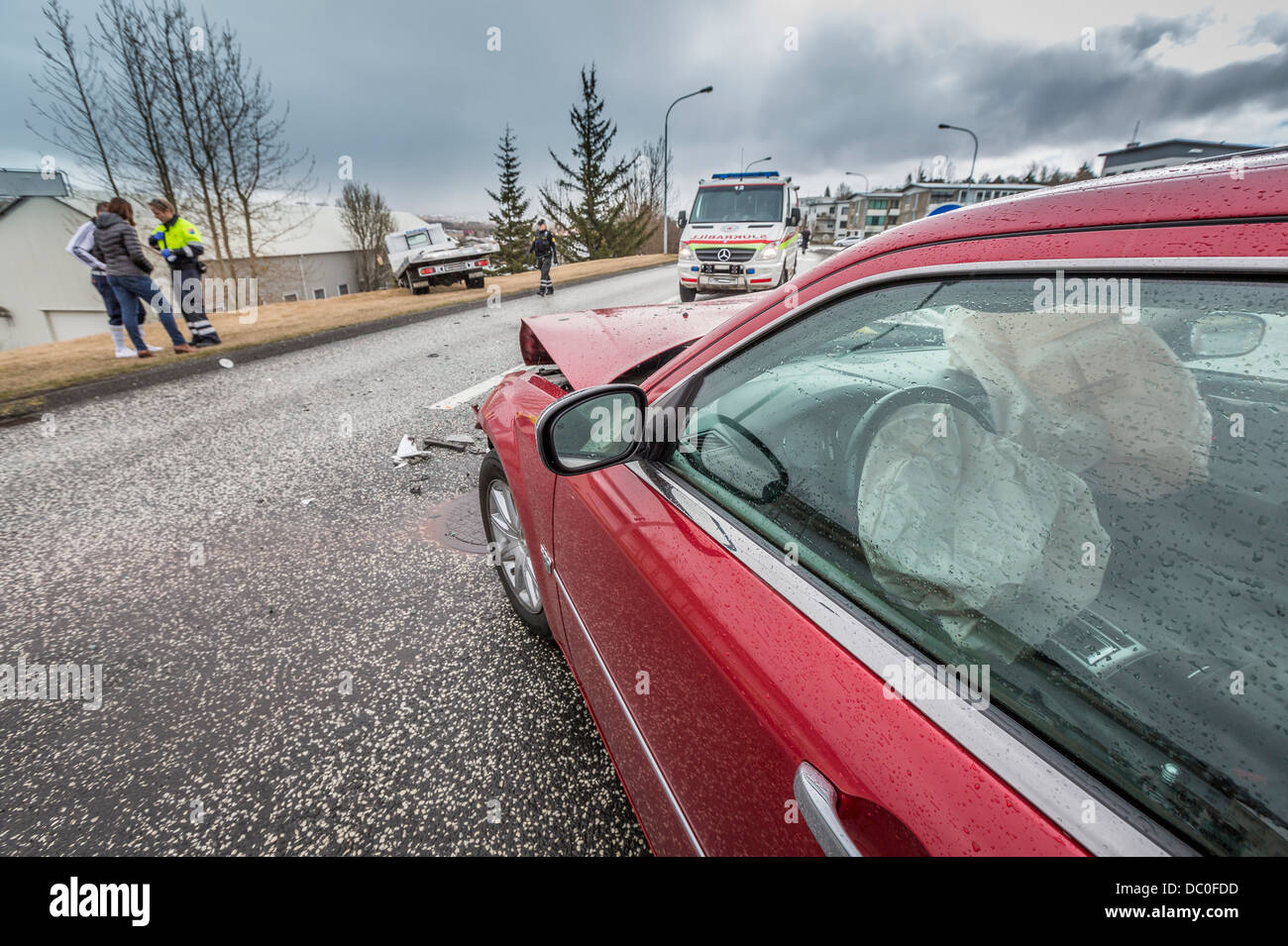 Car accident with airbag shown and ambulance.  Car crash in Kopavogur, suburb of Reykjavik, Iceland Stock Photo