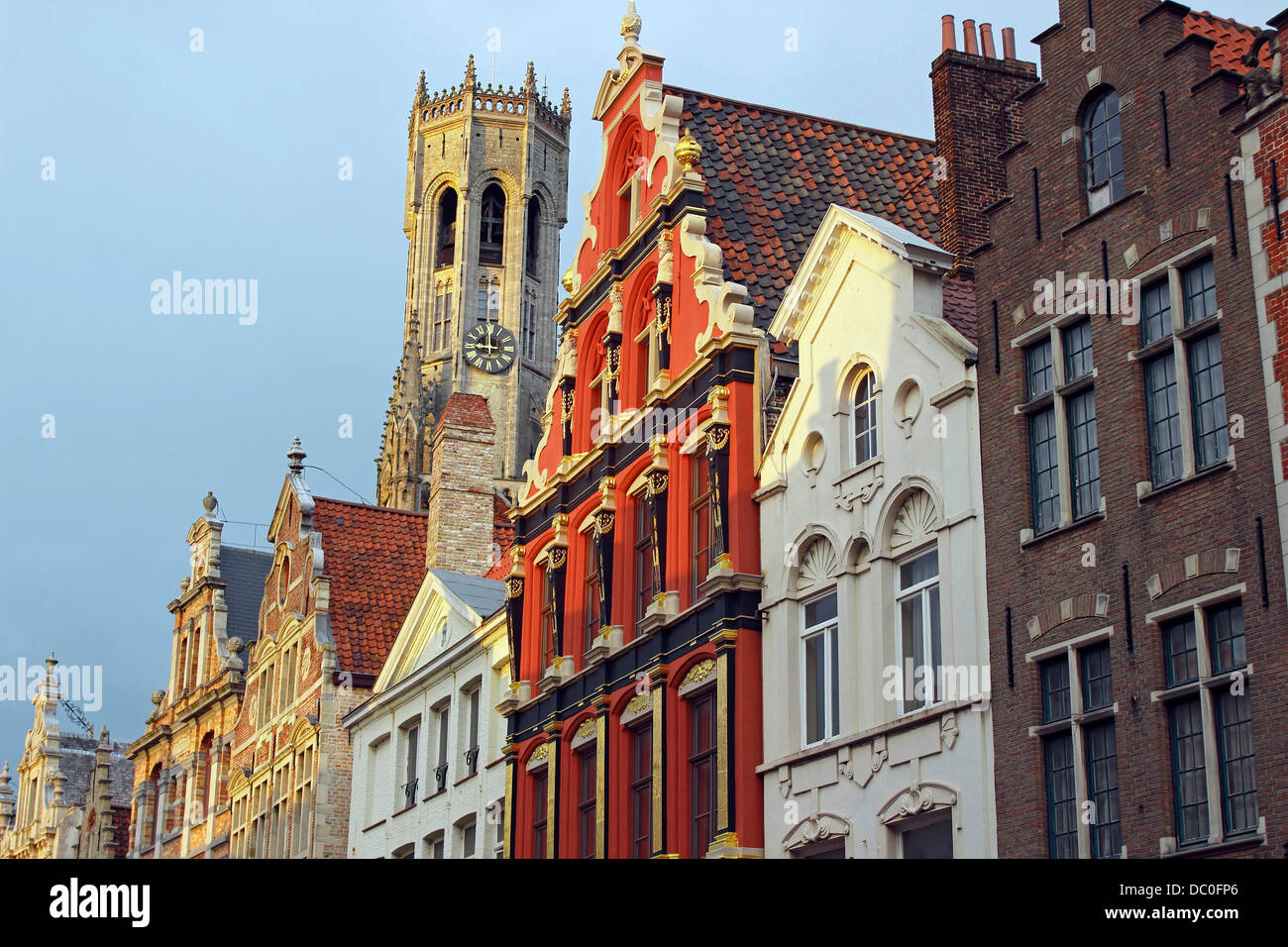 Bruges Belgium Flanders Europe Brugge gable roof guild houses in shopping district with Bell Tower Stock Photo