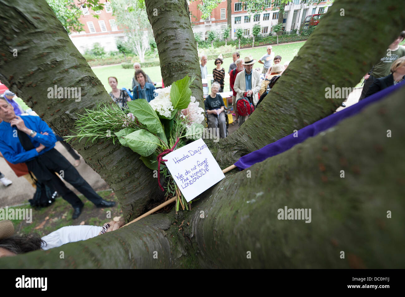 London, UK, 6th August, 2013. A ceremony of readings and song in memory of the victims of Hiroshima was held in Tavistock Square together with wreaths laid on a Japanese cherry tree in the gardens. The 6th Aug. 2013 marks the 68th anniversary of the atomic bomb explosion in 1945. Credit:  Lee Thomas/Alamy Live News Stock Photo