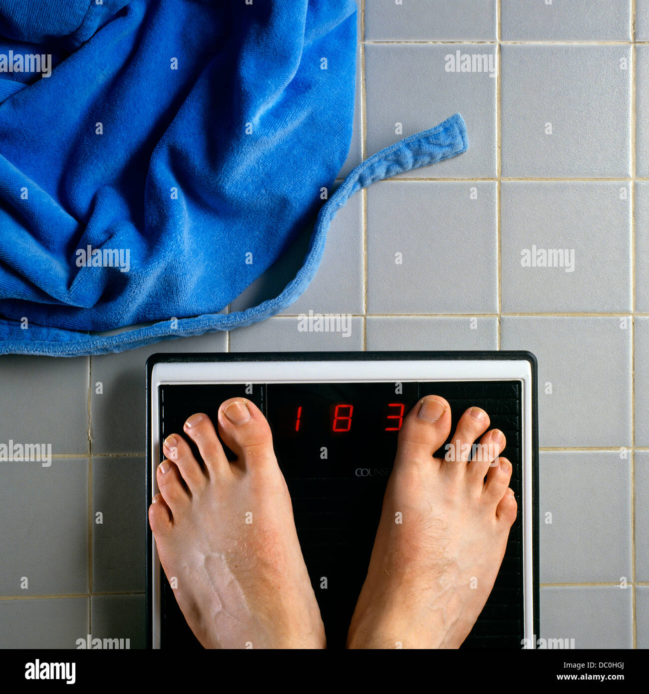 1990s Male Feet On Bathroom Scale Weight Of 183 Pounds Blue Terry Robe On Floor 1990s Male Feet On Bathroom Scale Weight Of 183 Pounds Blue Terry Robe On Floor