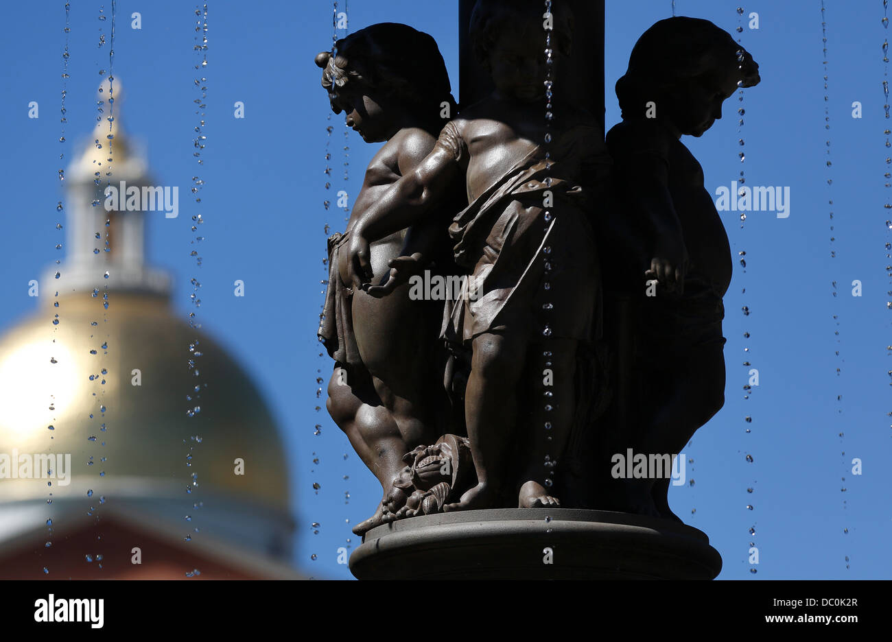 Figures on the Brewer Fountain in Park Square on the Freedom Trail with the State House dome, Boston, Massachusetts Stock Photo