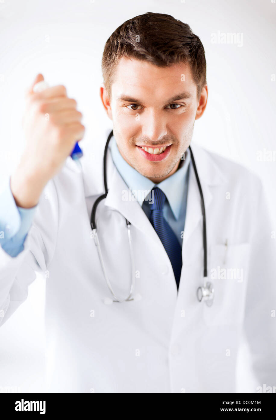evil doctor holding syringe with injection Stock Photo