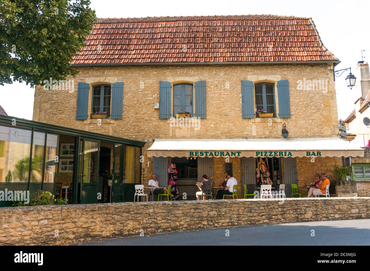 People sitting outside a Restaurant in the village of Trémolat, a commune in the Dordogne department in Aquitaine in south west France, Europe. Stock Photo