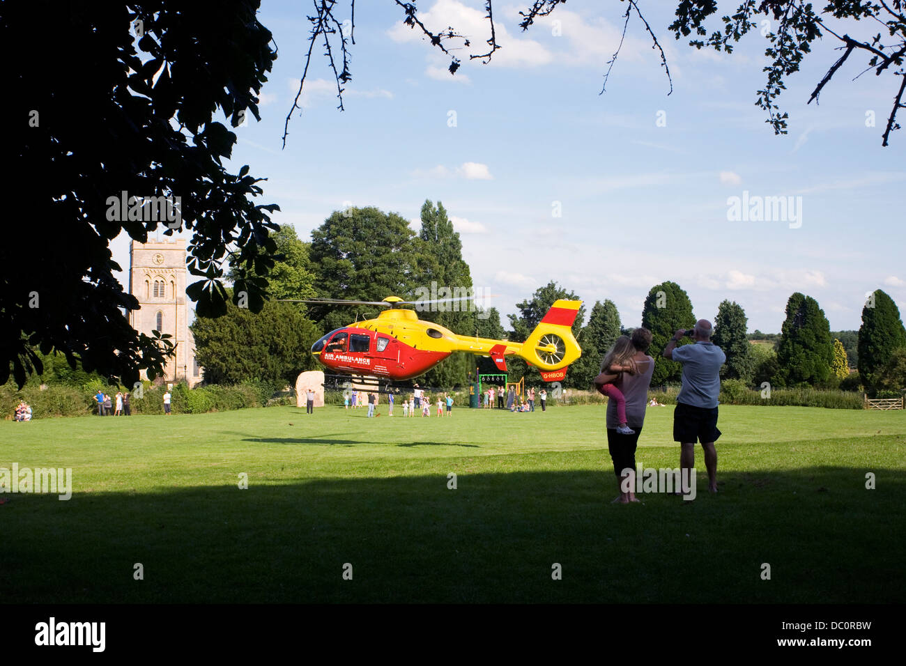 Berks, Oxon and Bucks air ambulance taking off from a town park. Stock Photo
