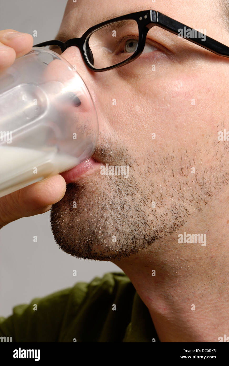 A man drinks a glass of milk Stock Photo
