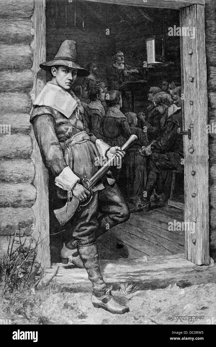 1600s PILGRIM MAN STANDING GUARD WATCH IN DOOR OF COLONIAL CABIN WITH MUSKET PILGRIMS INSIDE EATING THANKSGIVING MEAL Stock Photo