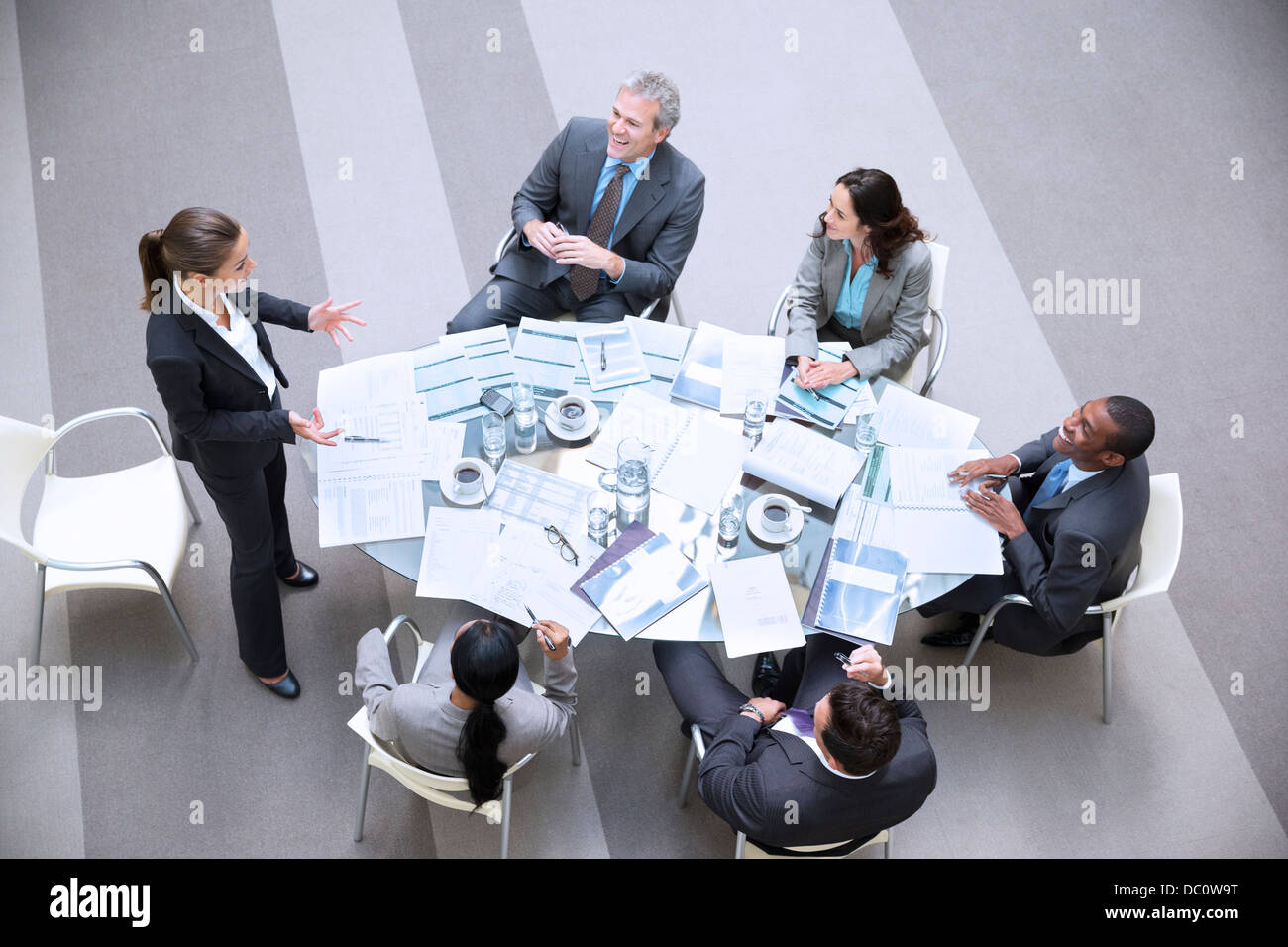 High angle view of gesturing businesswoman leading meeting Stock Photo