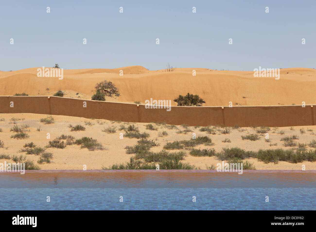 A concrete wall is erected to keep the shifting sands out from the oasis infinity swimming pools