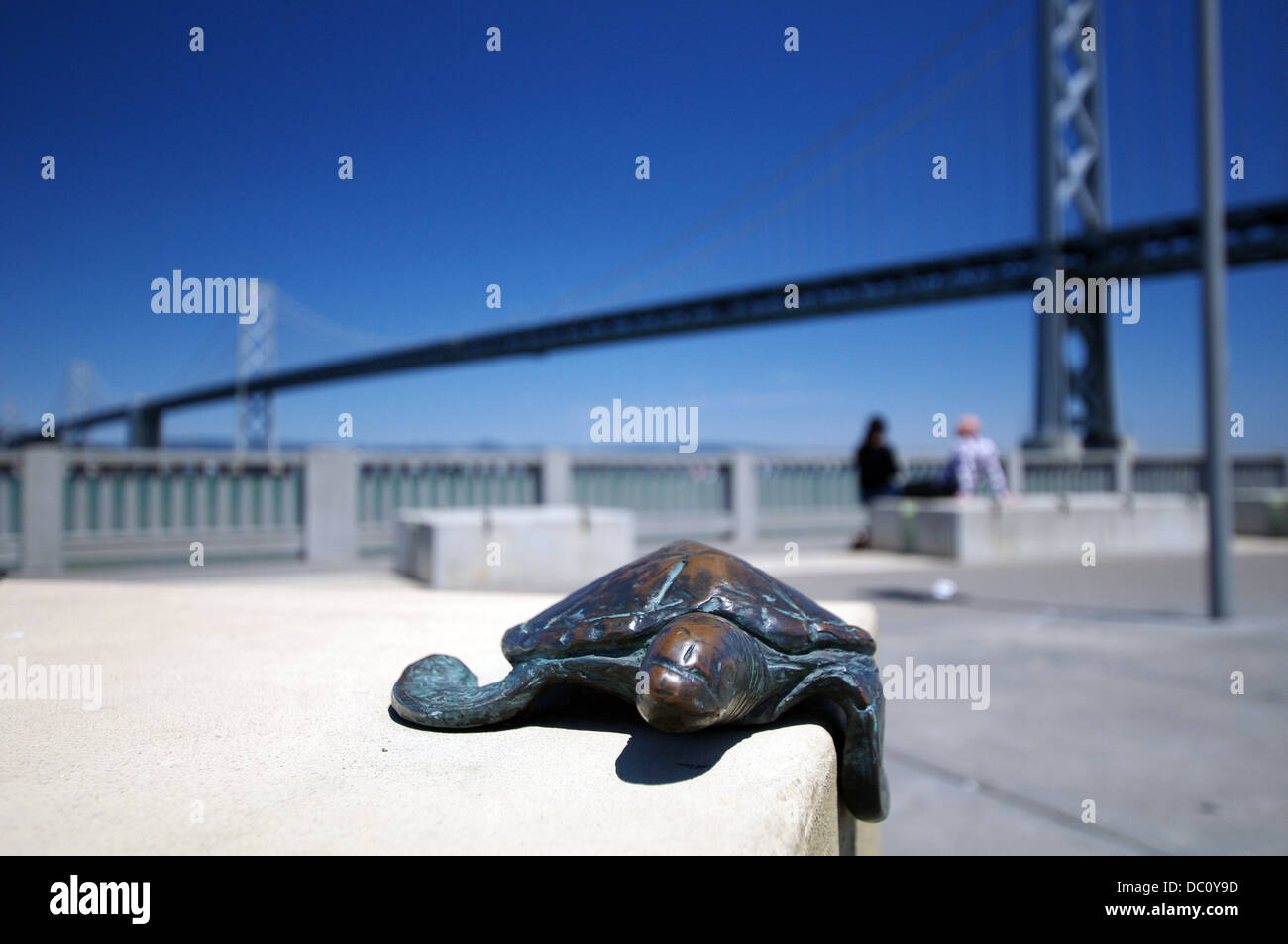 Sculpture of sea turtle in Rincon Park, San Francisco–Oakland Bay Bridge in the background: San Francisco, USA Stock Photo