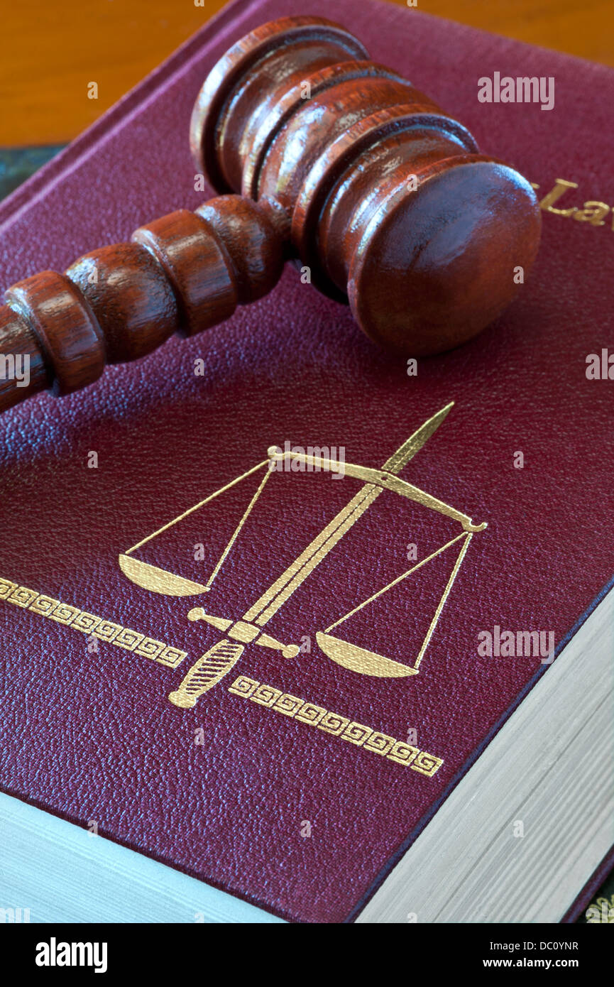 Law concept  Family Law book with scales of justice and double edged sword motif with Judges wooden gavel Stock Photo
