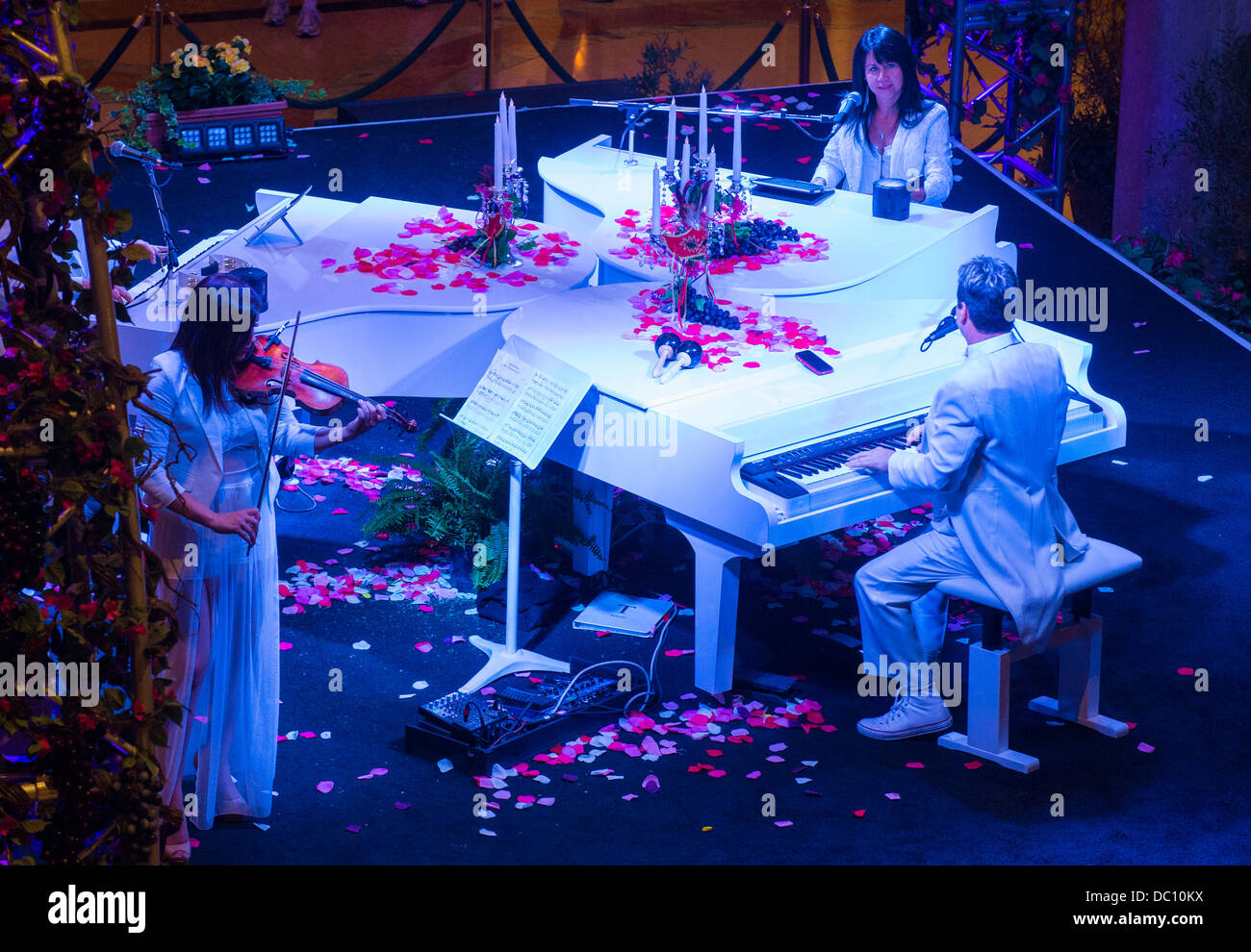 Pianists and a violinist perform at the Carnival experience festival in the Venetian Hotel in Las Vegas Stock Photo