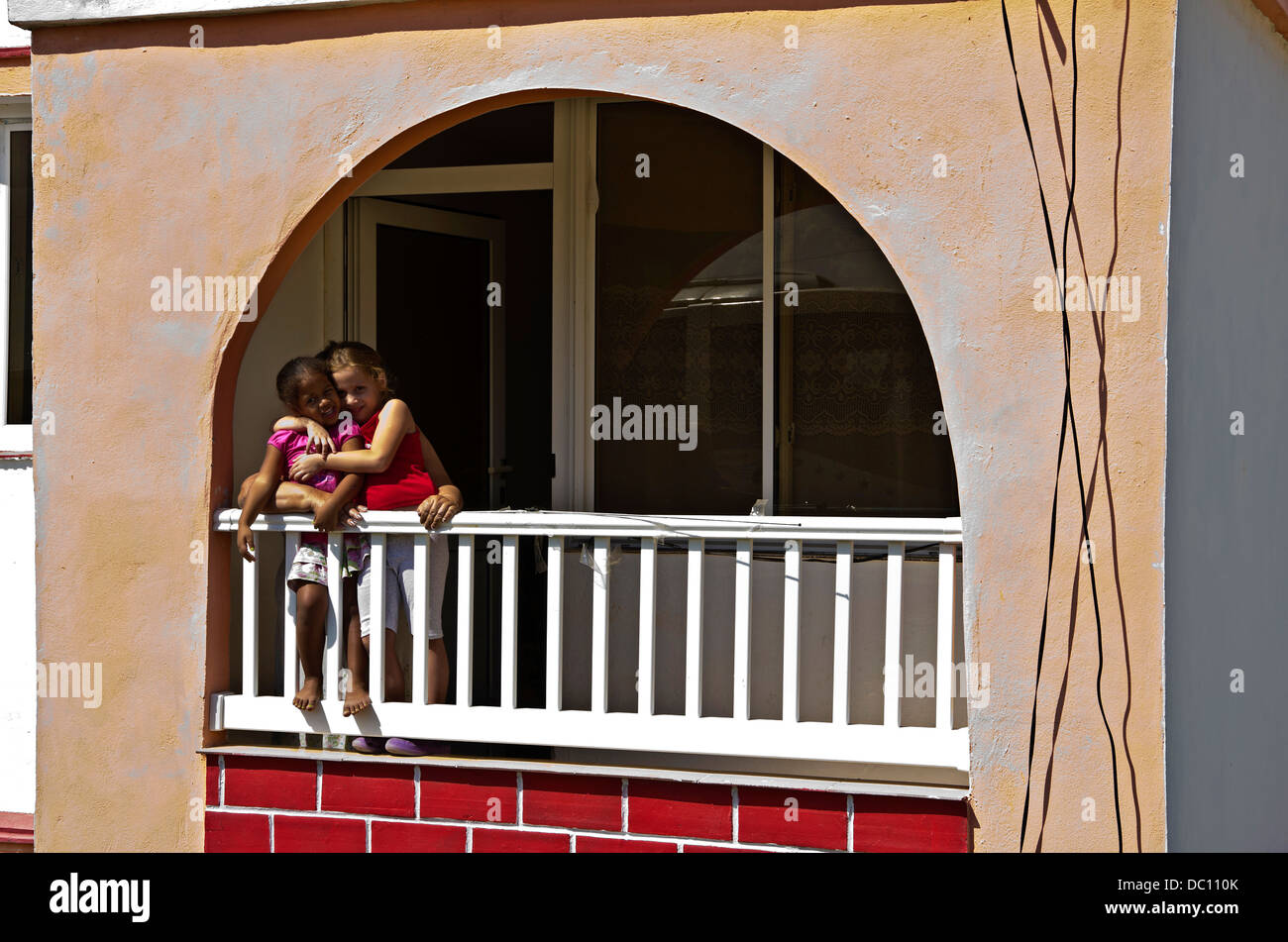 Two girls pose on balcony of apartment Alamar district Soviet-style apartment. Stock Photo