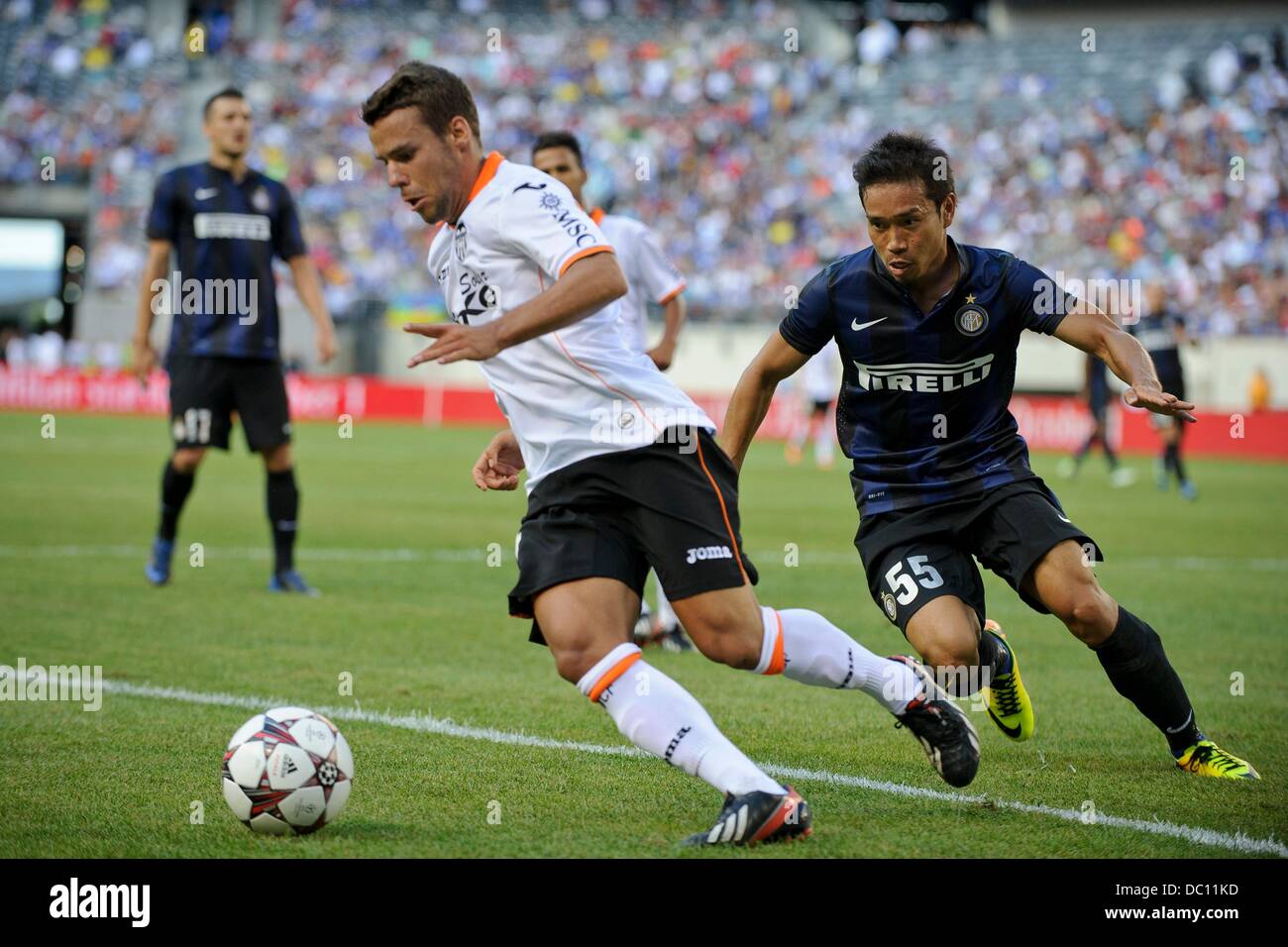 East Rutherford, New Jersey, USA. 4th Aug, 2013. August 04, 2013: Valencia midfielder Juan Bernat (14)looks to clear the ball away from Internazionale defender Yuto Nagatomo (55) during the Guinness International Champions Cup match between Valencia C.F. and Inter Milan at Met Life Stadium, East Rutherford, NJ. Valencia defeated Internazionale 4-0. © csm/Alamy Live News Stock Photo