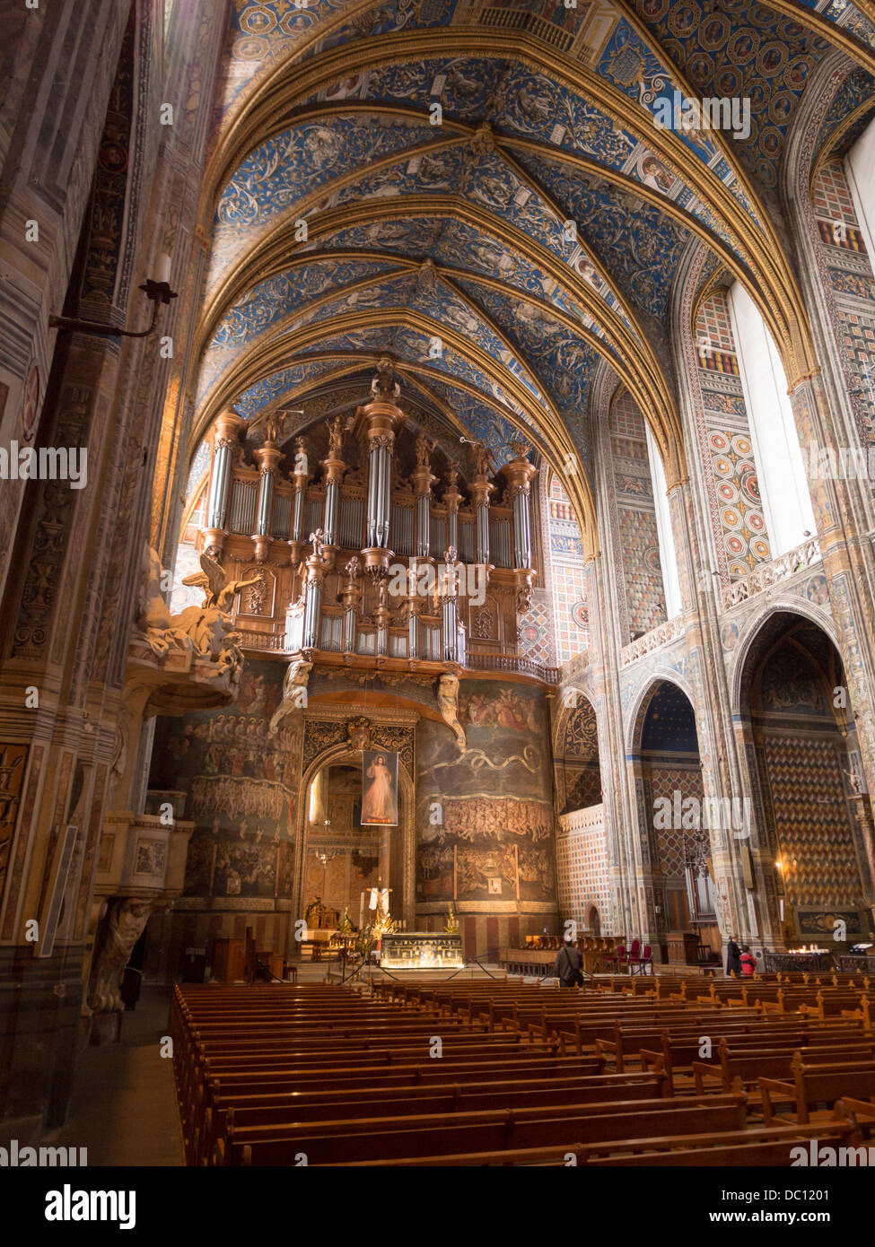Altar and the Last Judgement mural with Organ Pipes, pews. The front of the massive cathedral in Albi Stock Photo