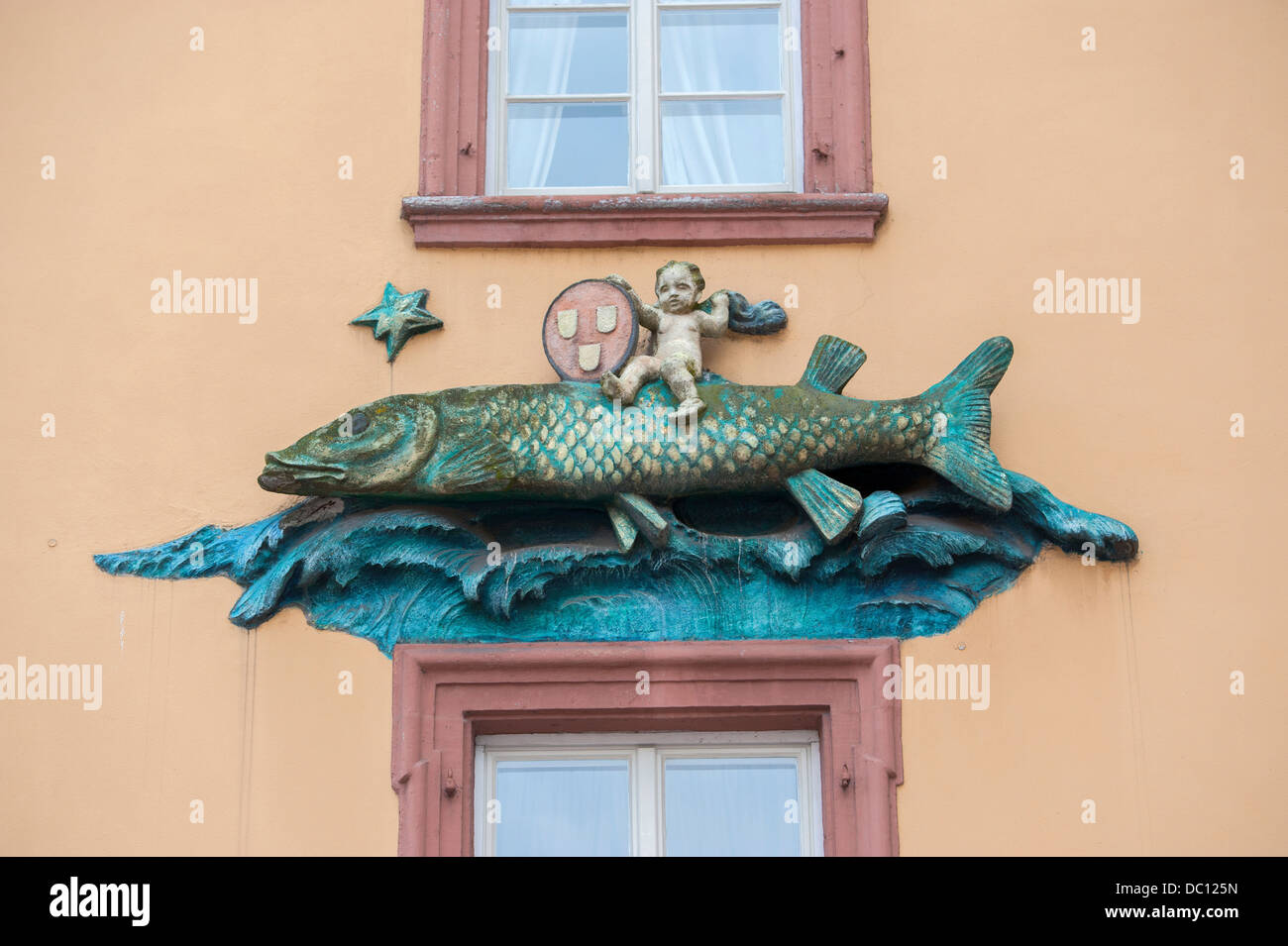 Europe, Germany, Baden-Wurttemberg, Heidelberg, Goldener Hecht hotel, fish relief sculpture on building. Stock Photo