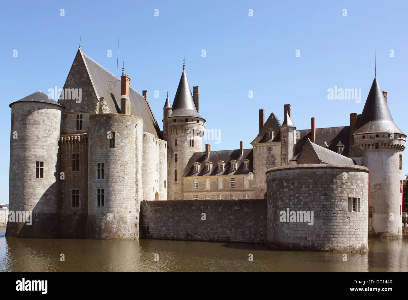Photograph of the Castle of the Sully-sur-Loire bordered by trees with its pond Stock Photo