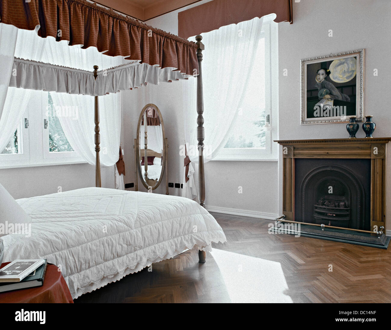Ancient Fireplace In The Classic Bedroom With Tester Bed Stock