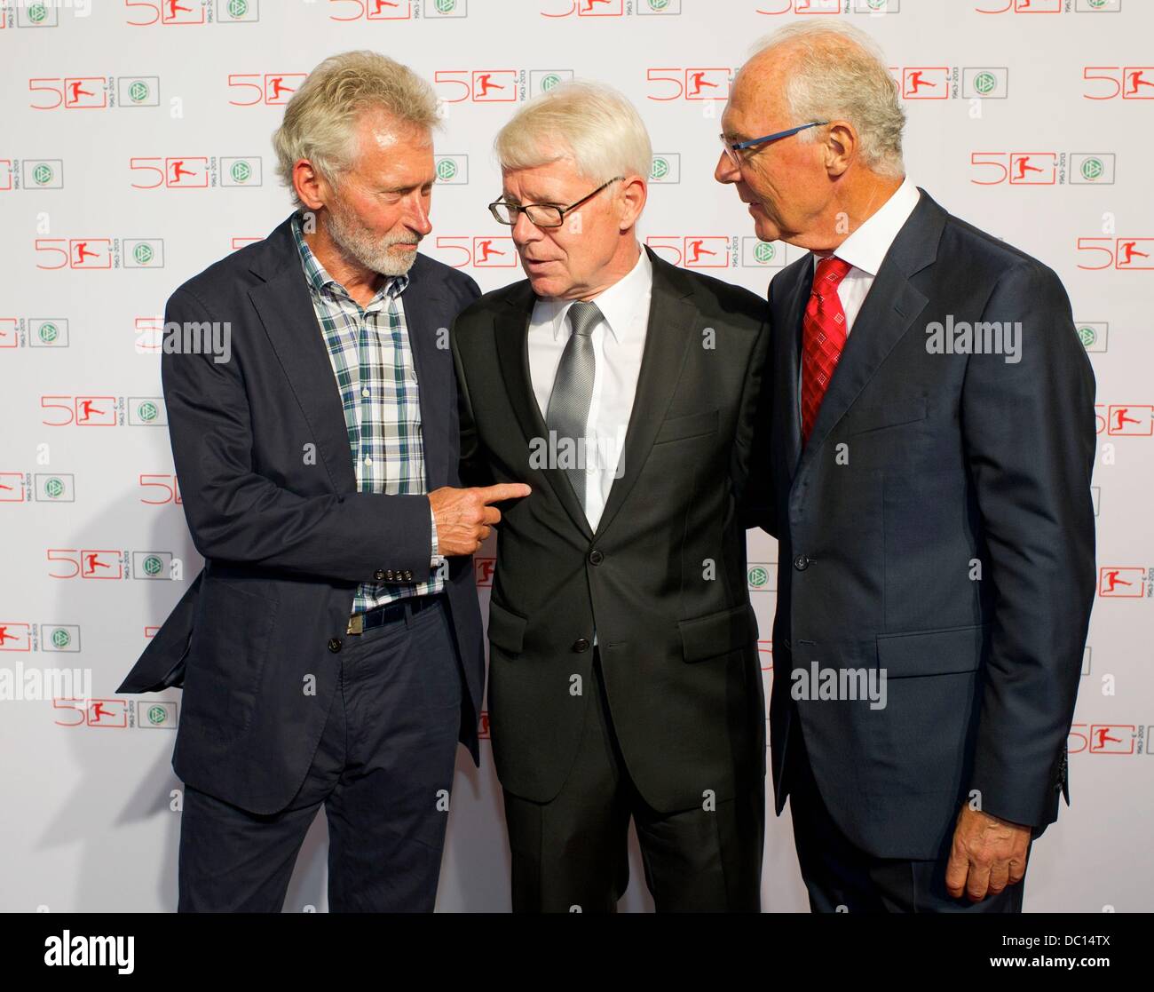 Berlin, Germany. 06th Aug, 2013. German Football League (DFL) President Reinhard Rauball (C) greets German soccer legends Franz Beckenbauer (R) and Paul Breitner (L) prior to an event to celebrate the 50th anniversary of the German Bundesliga in Berlin, Germany, 06 August 2013. Photo: Tim Brakemeier/dpa/Alamy Live News Stock Photo
