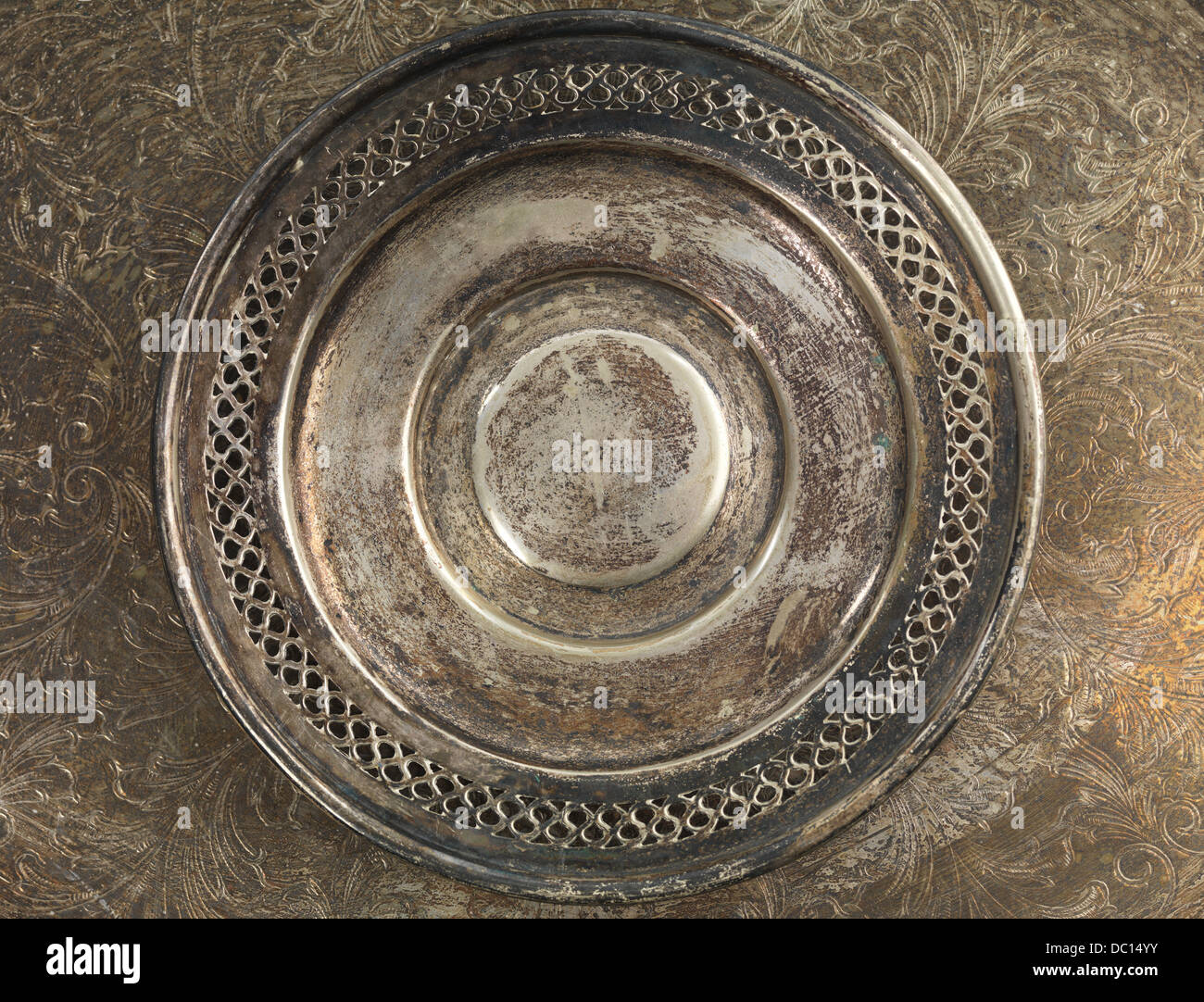 Round rustic silverware plate on metal background Stock Photo
