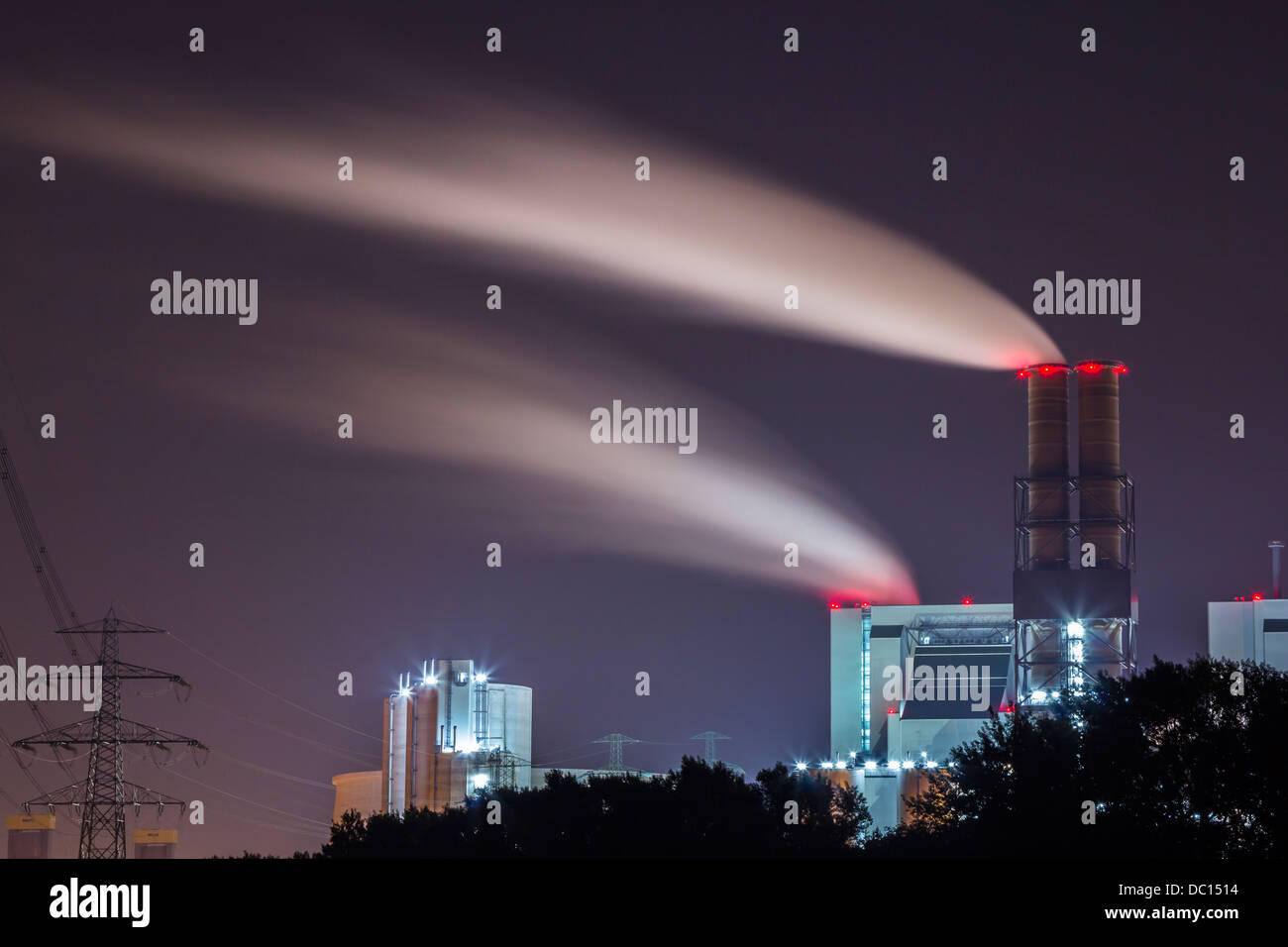 Power plant with smoking chimneys at night Stock Photo - Alamy