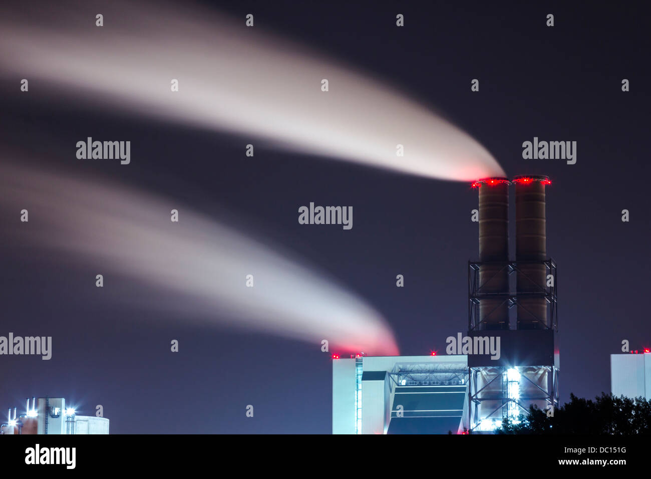 Power plant with smoking chimneys at night Stock Photo - Alamy