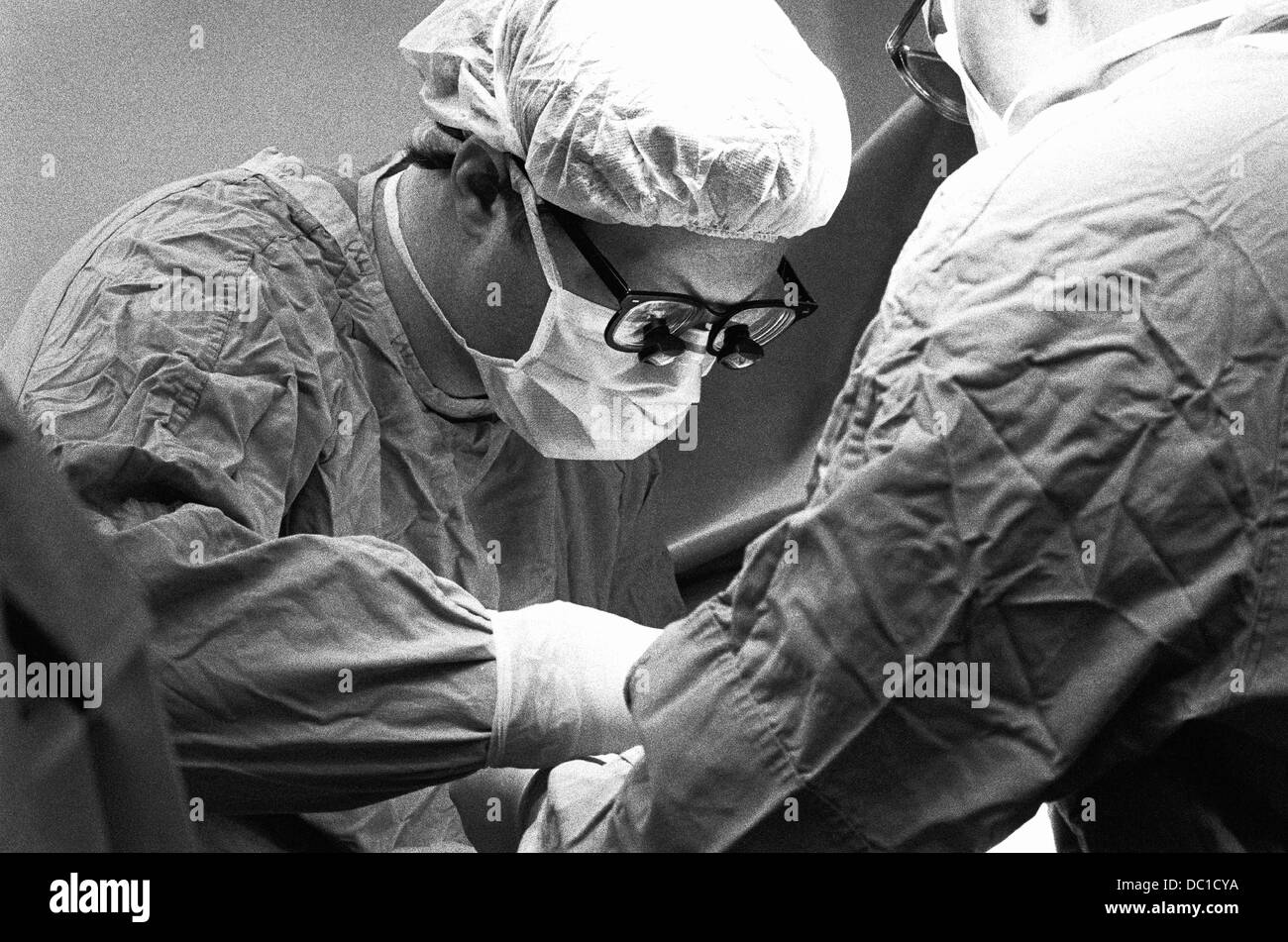 Surgeon with magnifying glasses Stock Photo Alamy