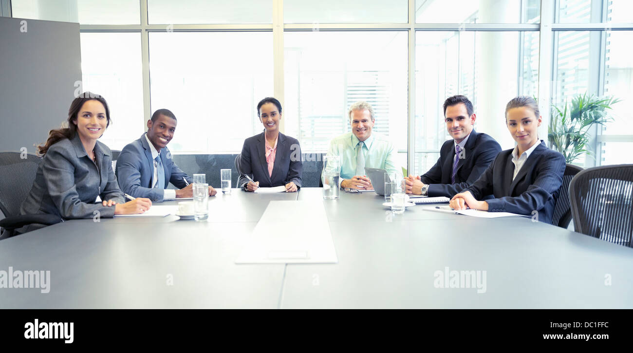 Portrait of confident business people at table in conference room Stock Photo