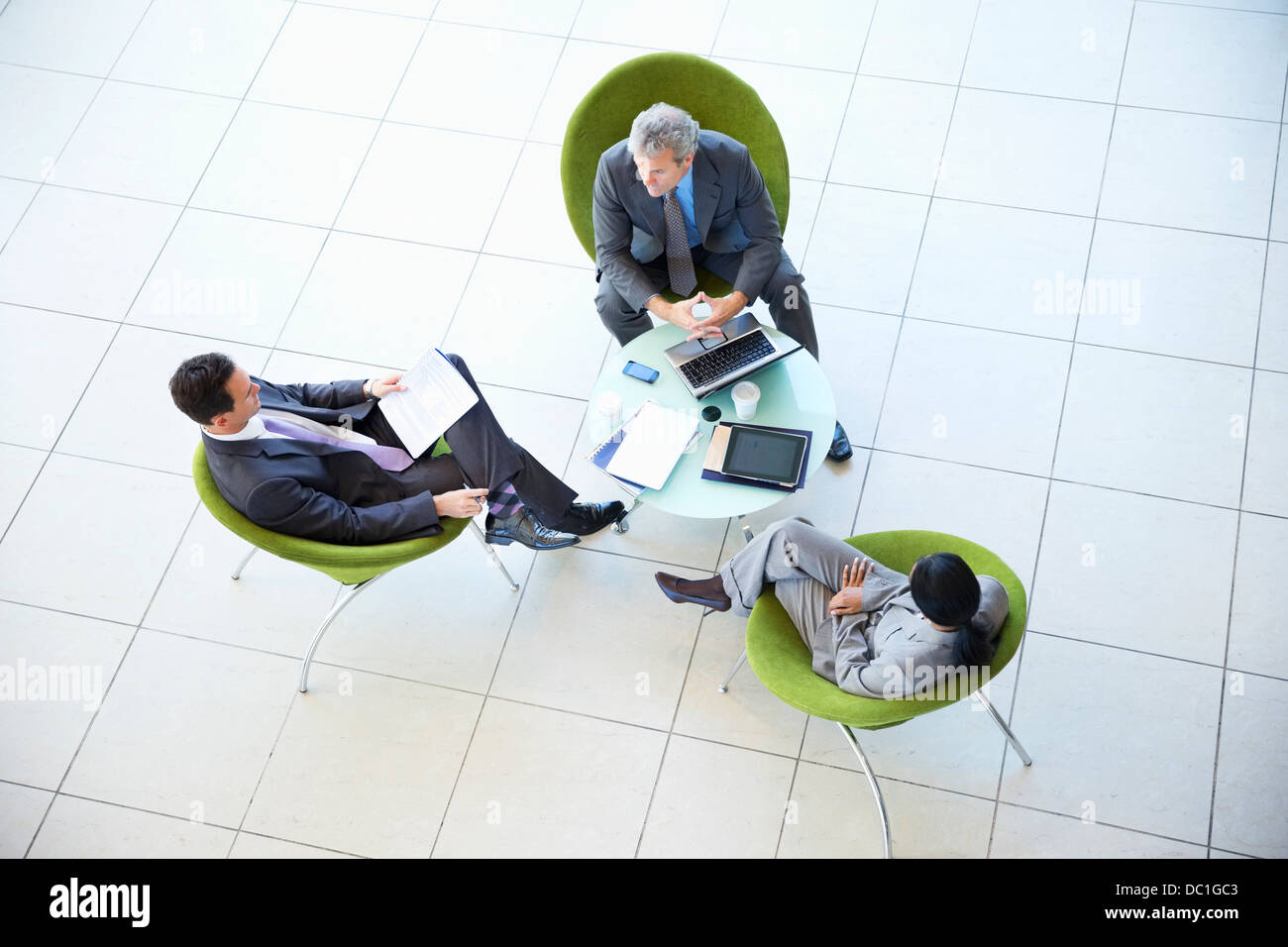 High angle view of business people meeting in lobby Stock Photo