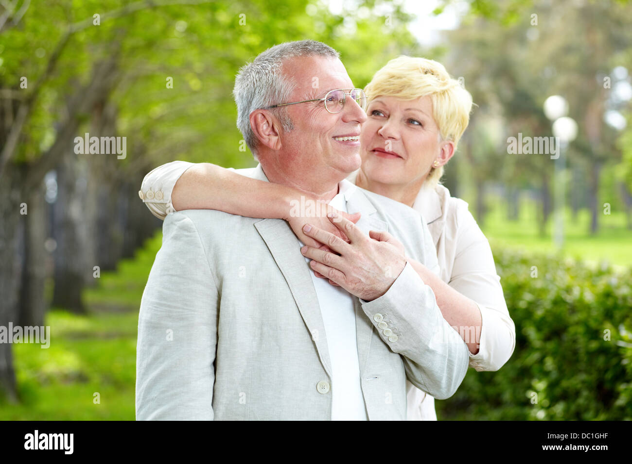 Portrait of happy mature woman looking at her husband outside Stock Photo