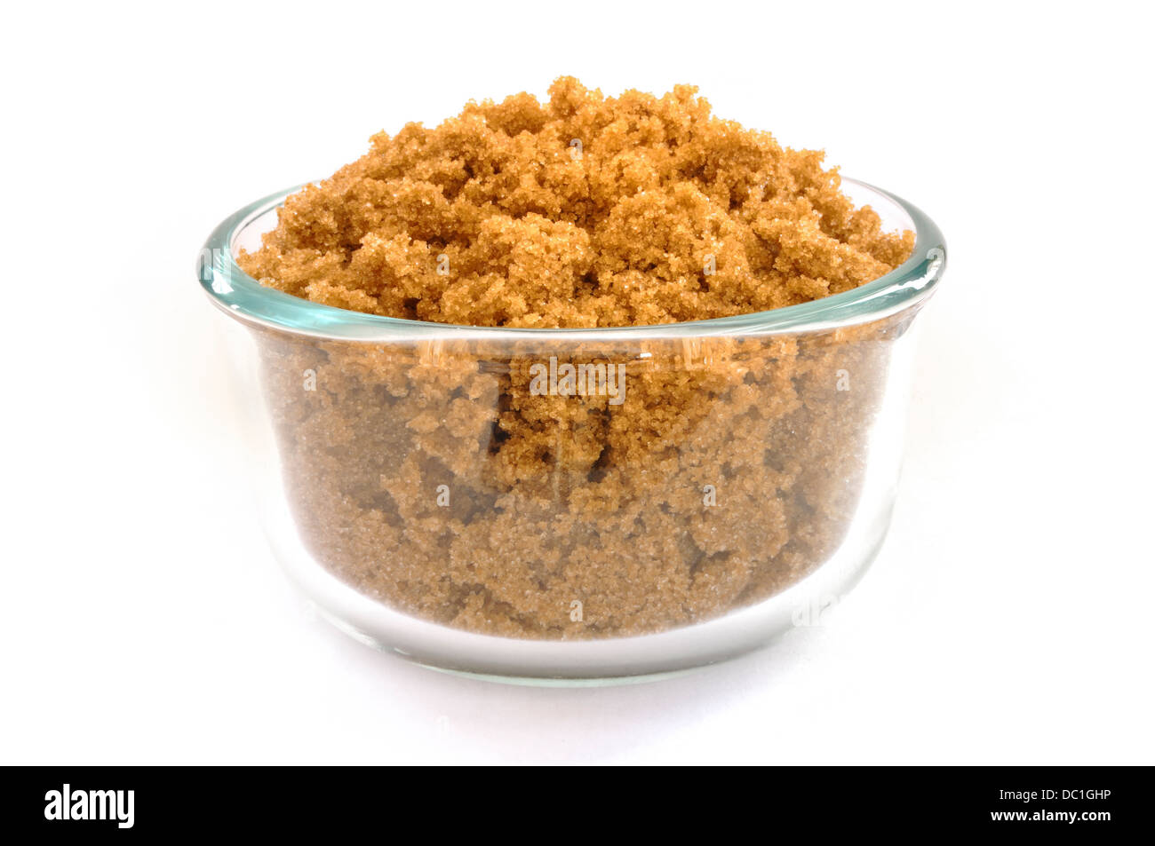 Brown Sugar in a Glass Bowl Isolated on White Stock Photo