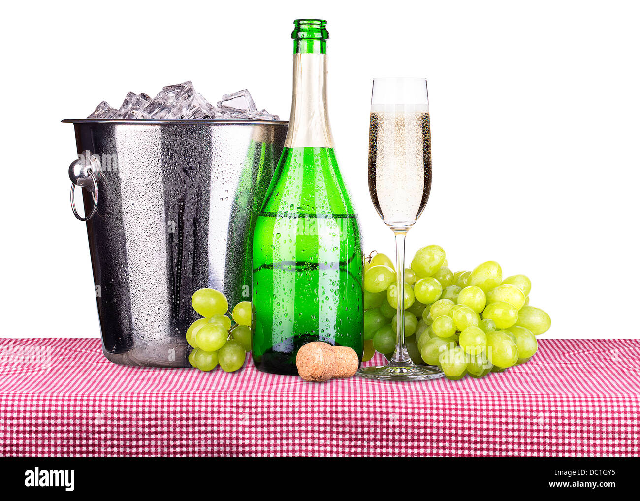 picnic lunch on a red and white gingham tablecloth including a champagne in ice bucket and grapes Stock Photo