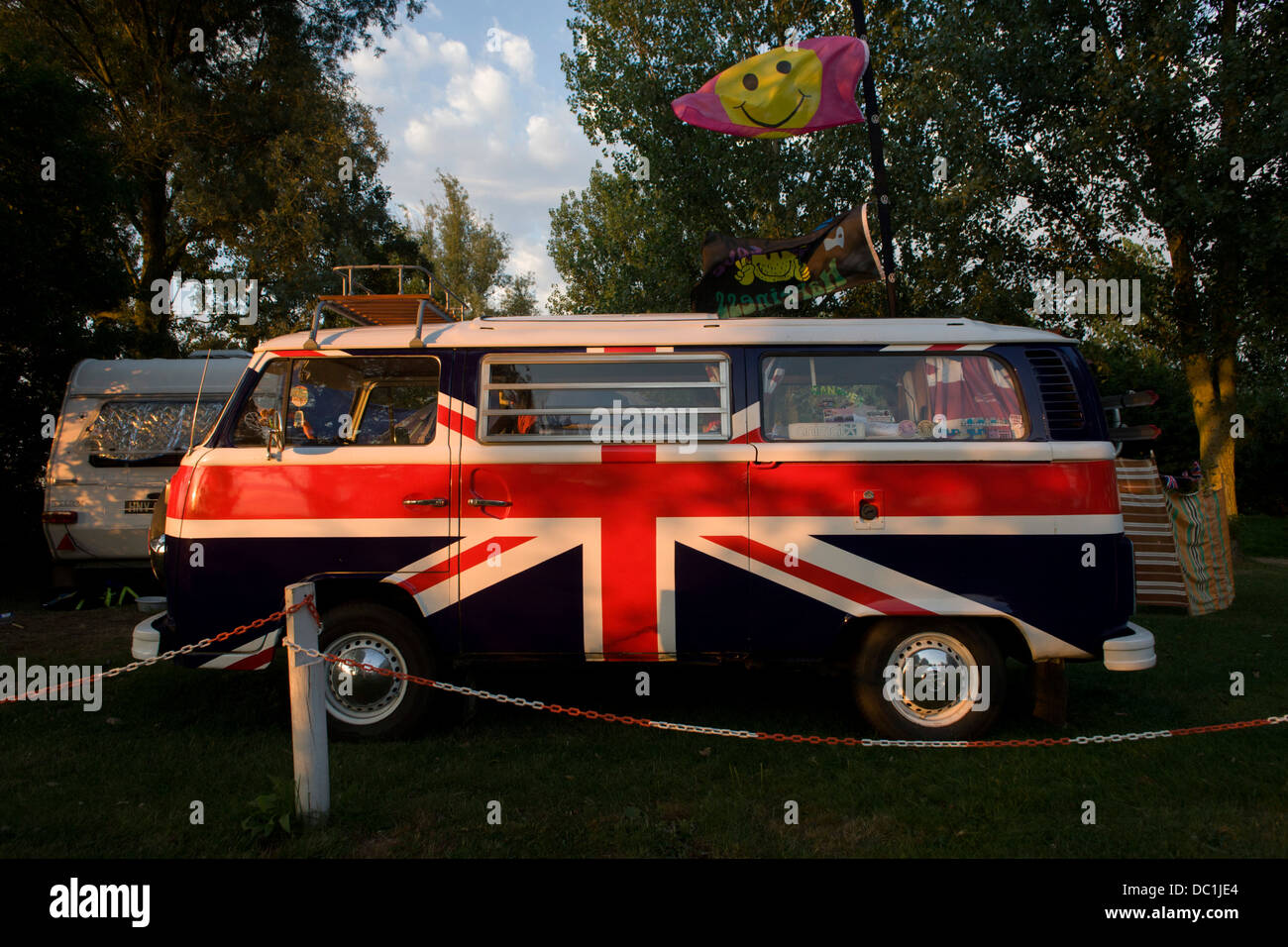 A VW camper van adorned with British Union Jacks colours, on a campsite at Reedham on the