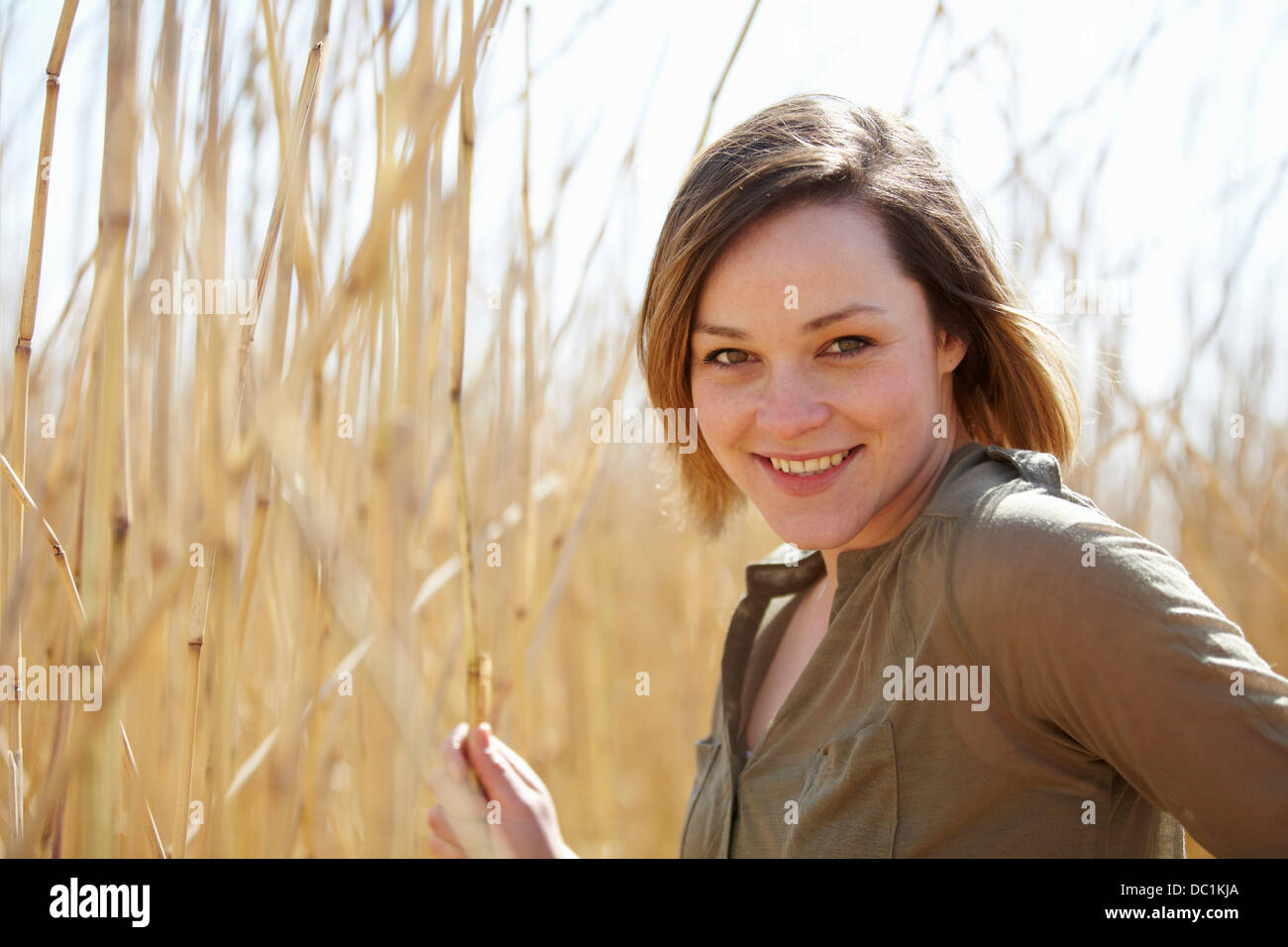 Portrait of young woman in front of reeds Stock Photo