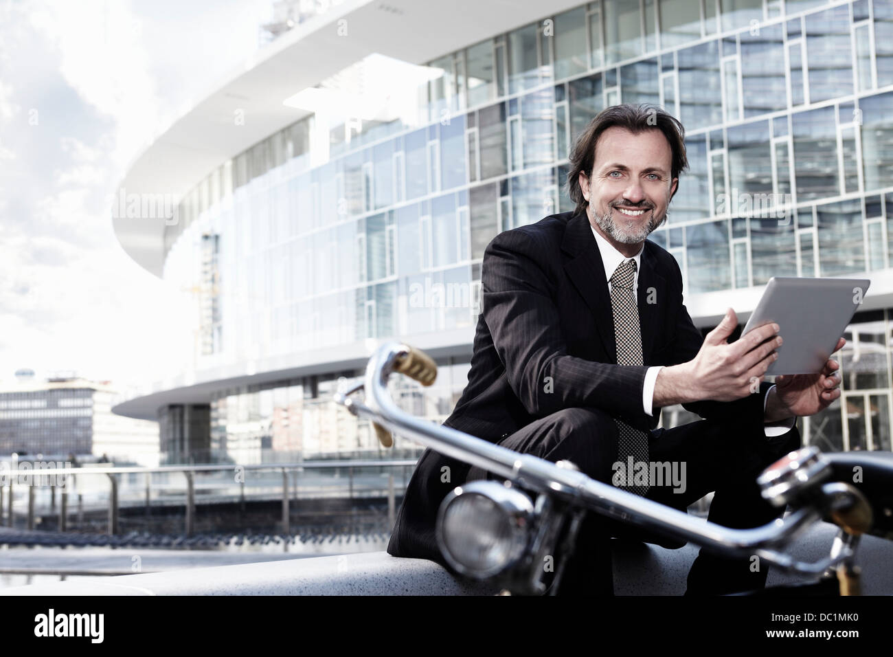 Mid adult businessman using digital tablet in city, portrait Stock Photo