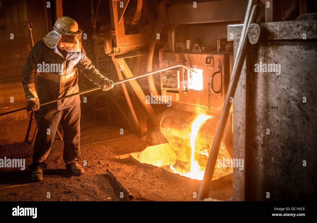 Steel worker and molten metal in steel foundry Stock Photo