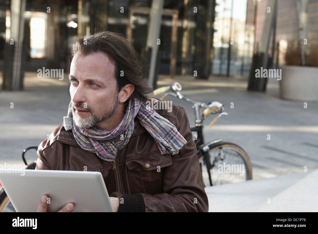 Mid adult man using digital tablet in city Stock Photo