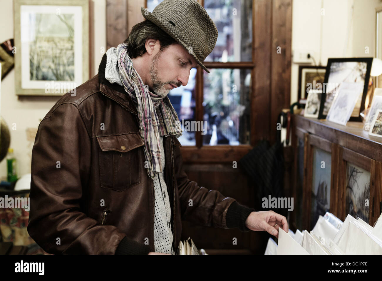 Mid adult man browsing in antique shop Stock Photo