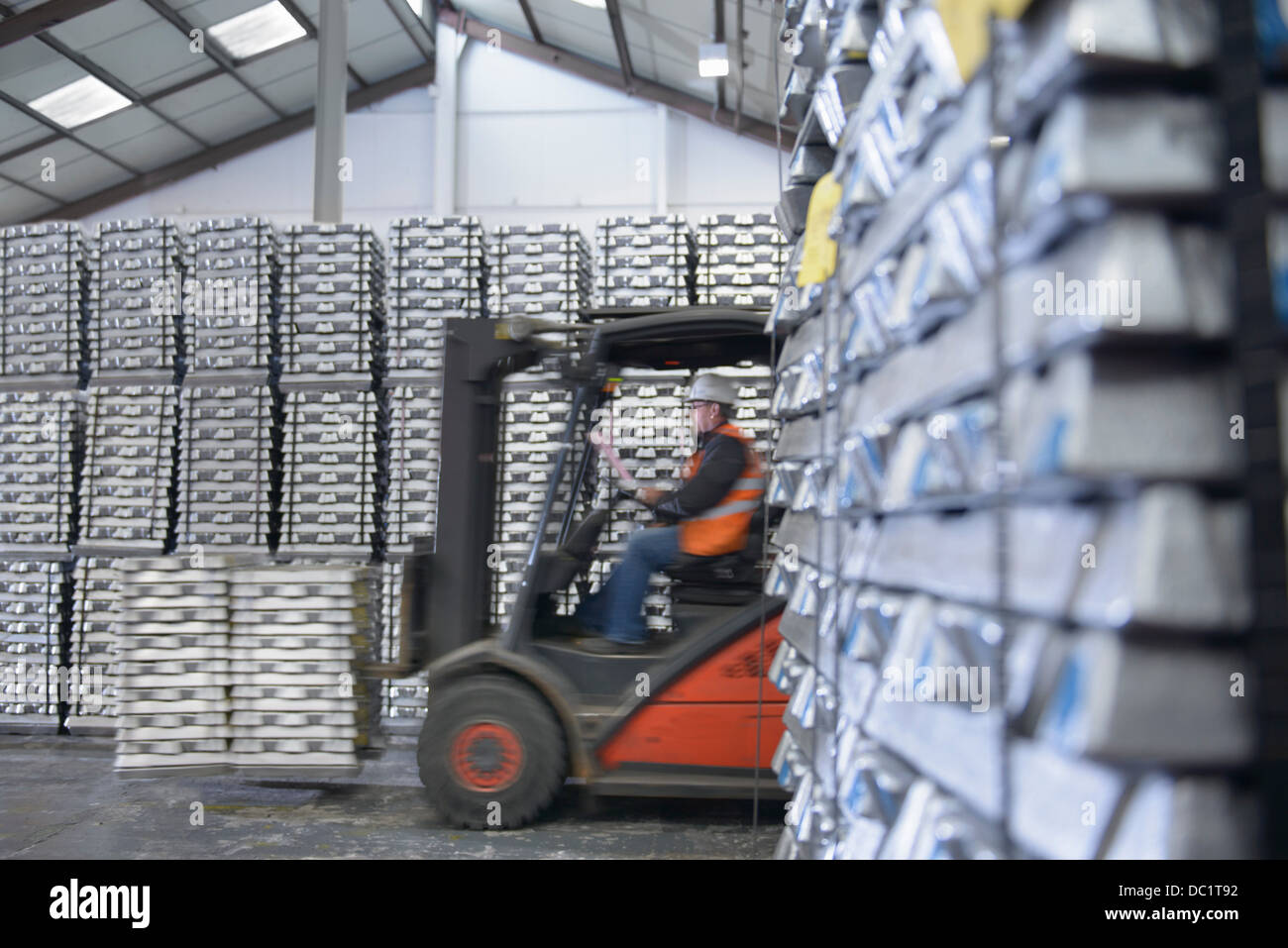 Forklift truck moving stock in warehouse Stock Photo
