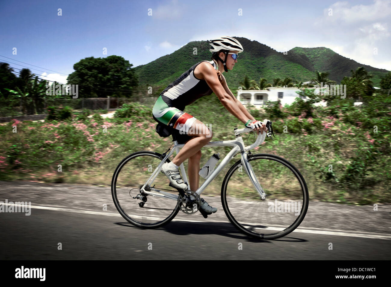 Mid adult triathlete cycling on road Stock Photo