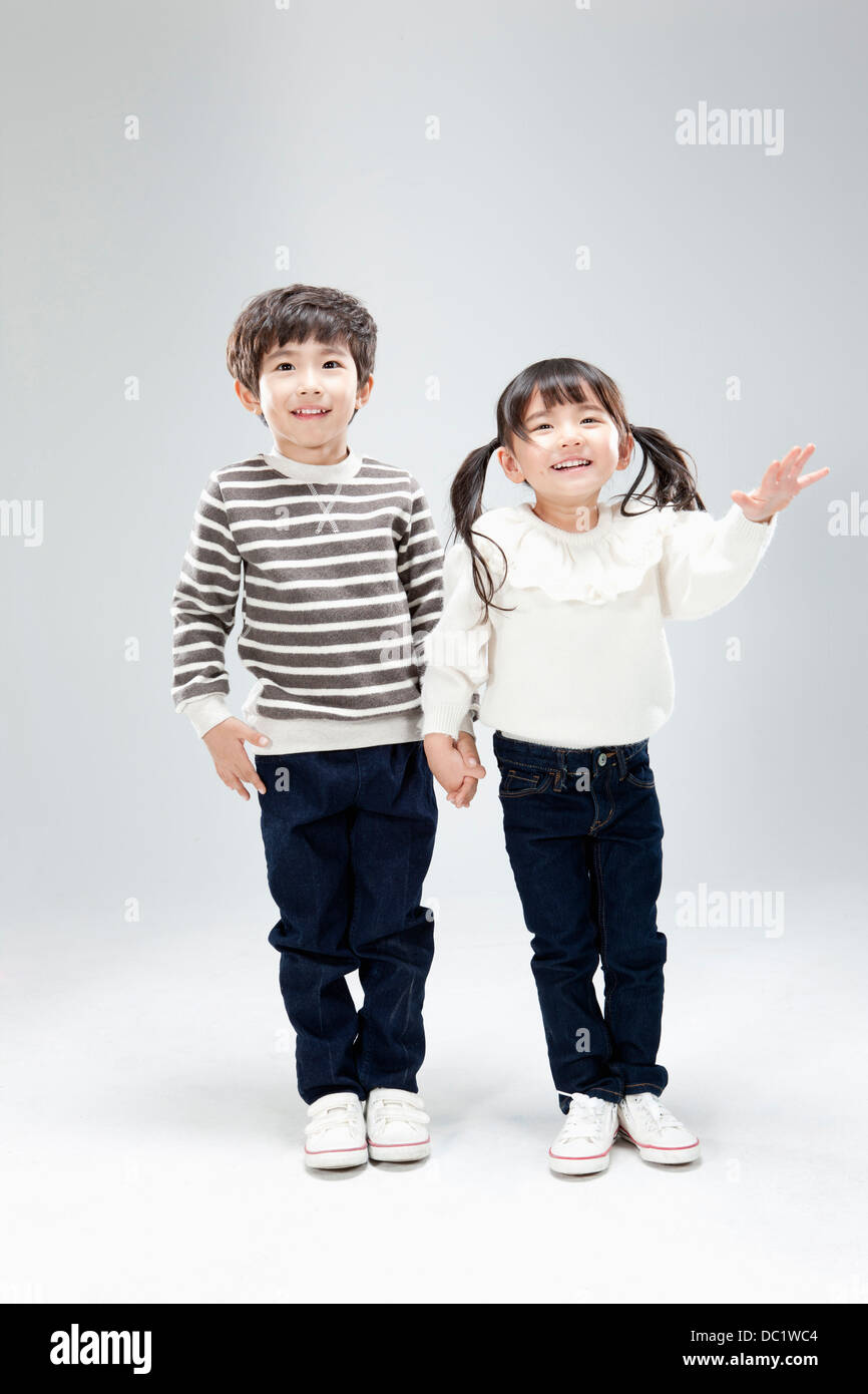 a boy and a girl hand in hand Stock Photo - Alamy