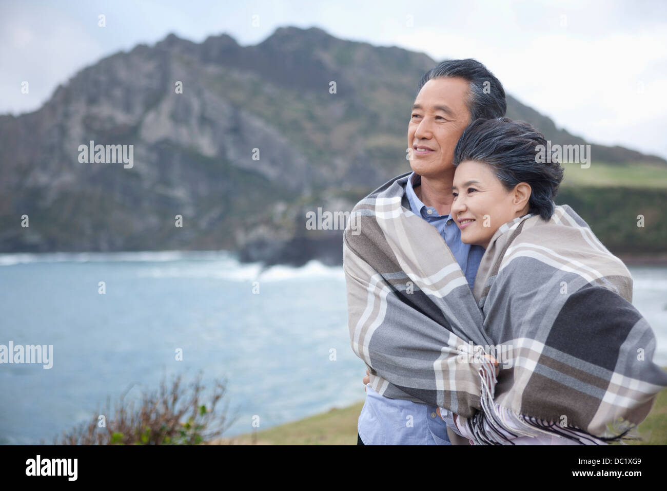 Middle aged asian couple hugging and smiling hi-res stock photography ...