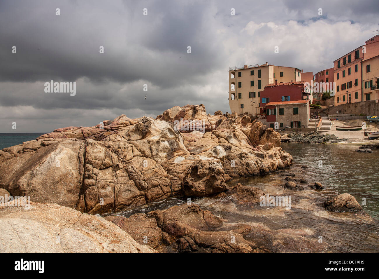 Rocks and houses Marciana town, Elba Island, Italy Stock Photo