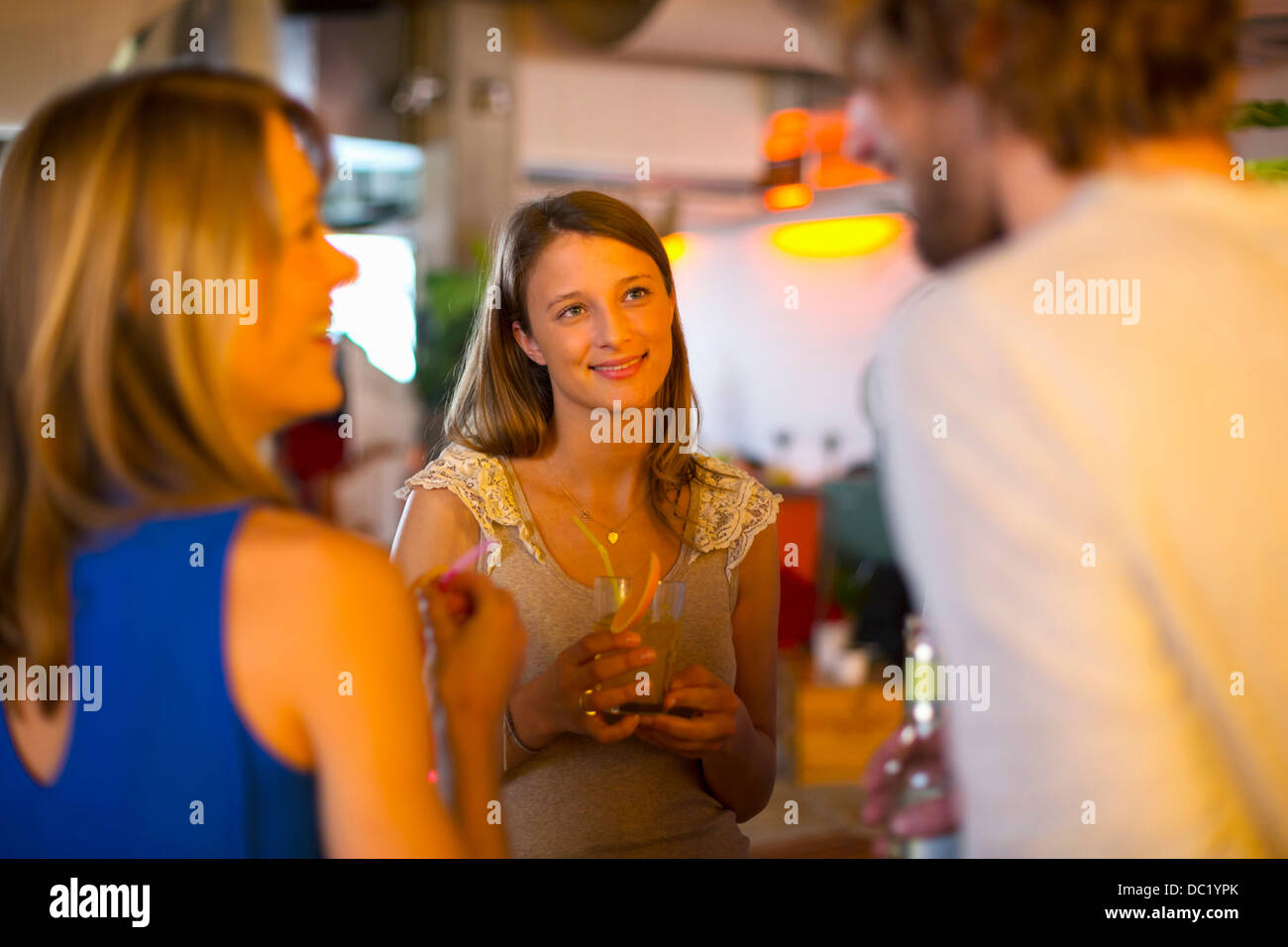 Friends enjoying drinks together in bar Stock Photo