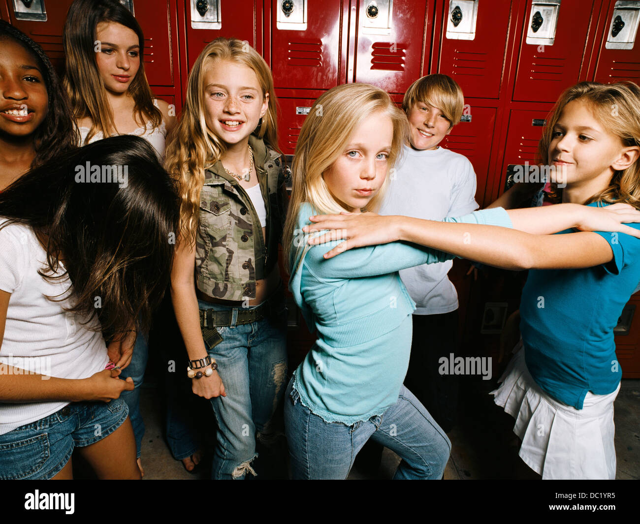 Girls posing in school locker room, portrait Stock Photo