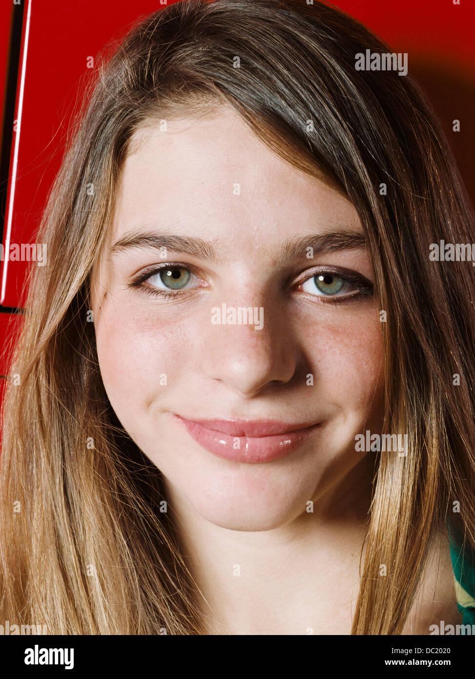 Girl smiling in school locker room, close up Stock Photo